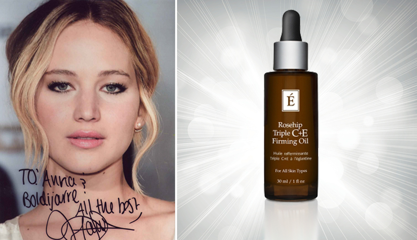 An autographed portrait of celebrity Jennifer Lawrence next to Eminence Organics' Rosehip Triple C+E Firming Oil.
